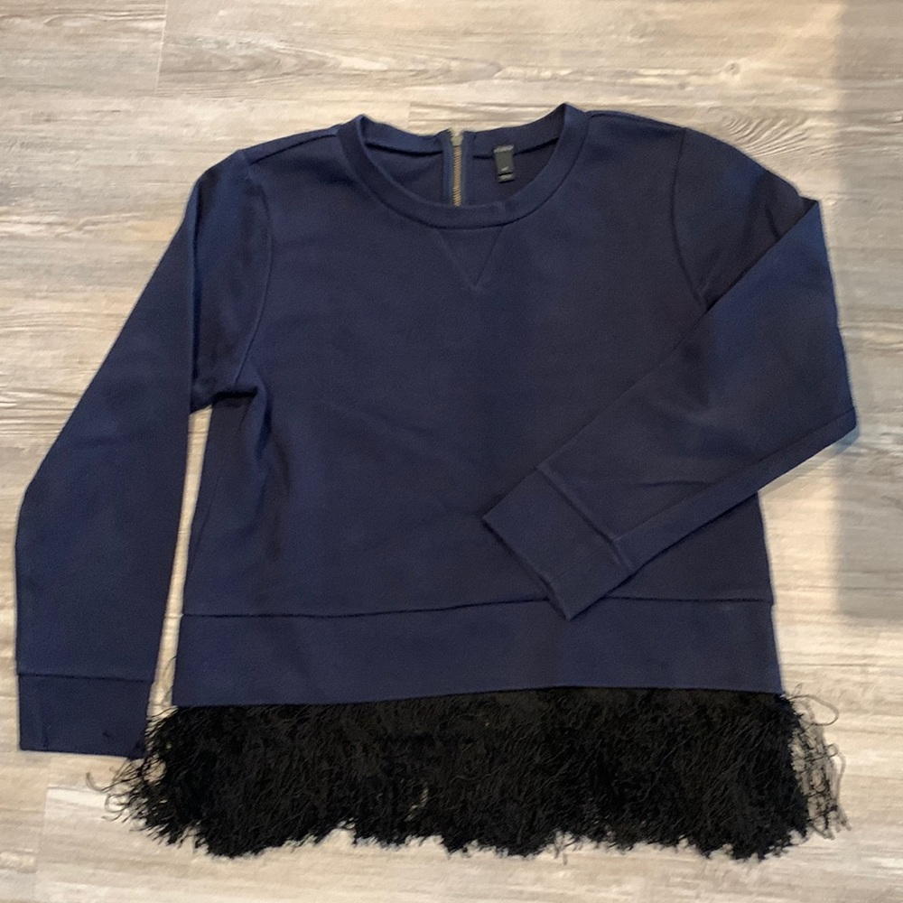 Navy sweatshirt with bottom fringes.